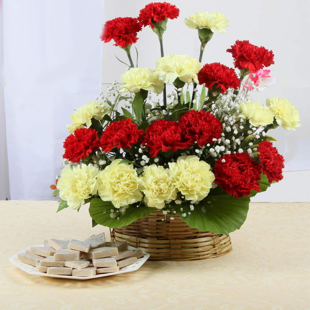 Arrangement of Red and Yellow Carnations with Kaju Katli Sweet